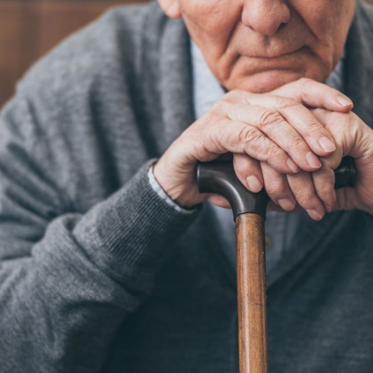 cropped-view-of-upset-retired-man-with-walking-can-TAXJUL5