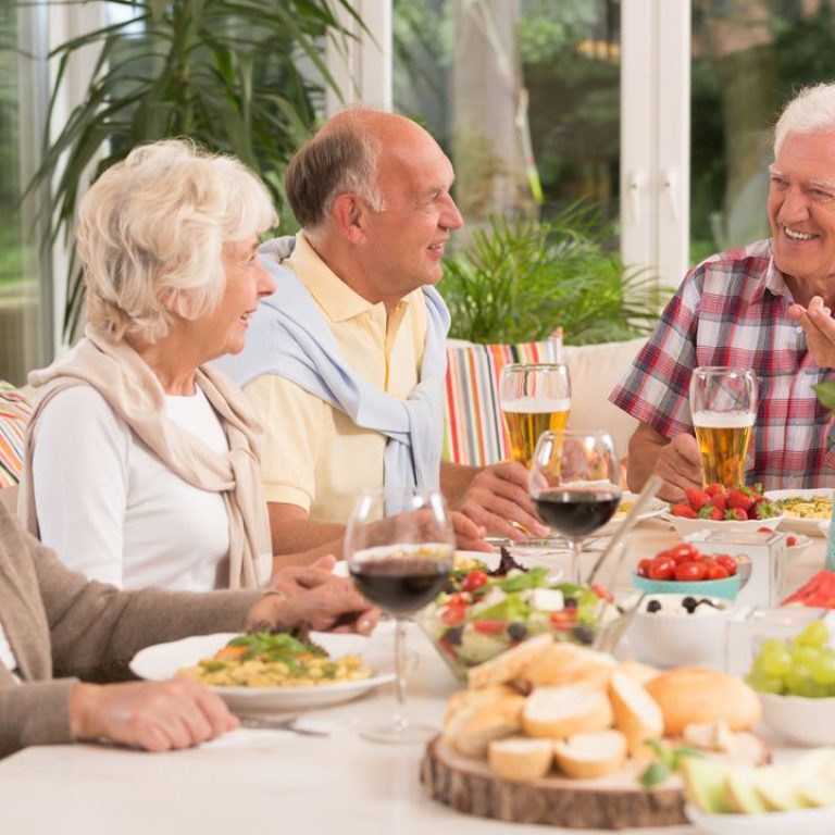 group-of-happy-seniors-eating-a-dinner-PAFFJJQ