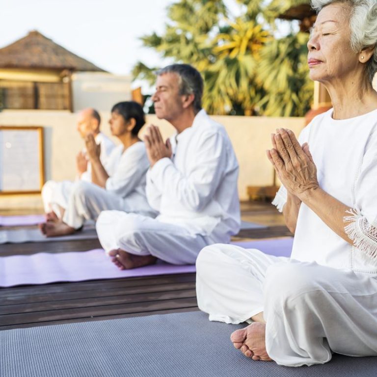 group-of-seniors-practicing-yoga-in-the-morning-DYG7MCU