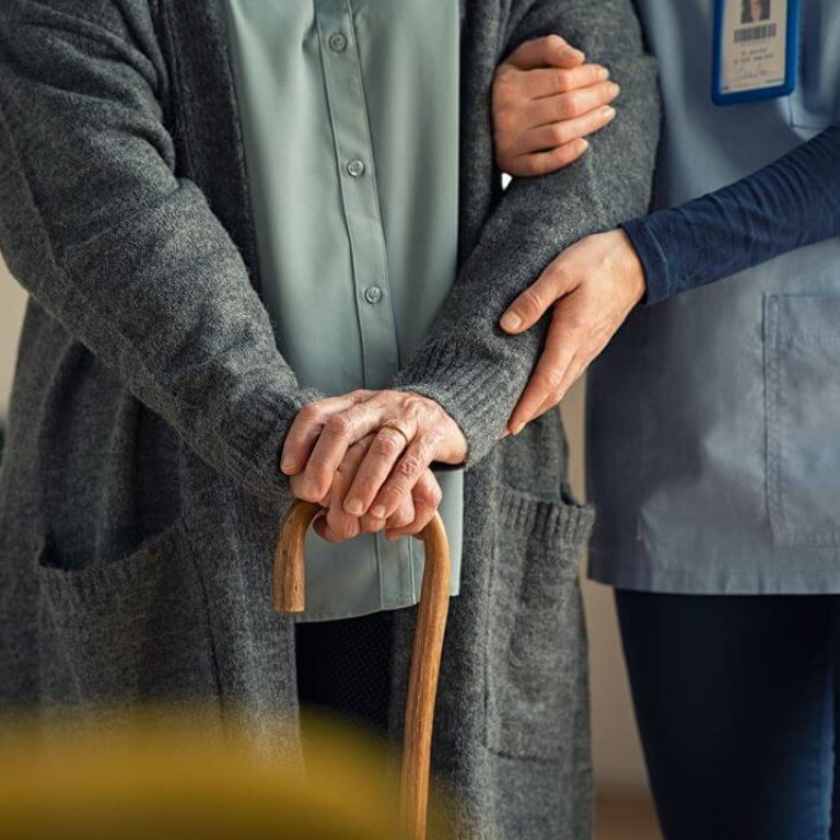 nurse-assisting-senior-with-walking-cane-BC7VPGU
