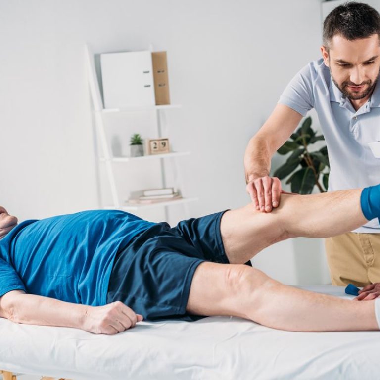 rehabilitation-therapist-assisting-senior-man-exer-G6EV4BJ